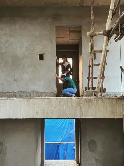 Our architects on site, taking measurements and inspecting the progress. This view clearly shows the split-level nature of the design, with one floor overlooking the space below.