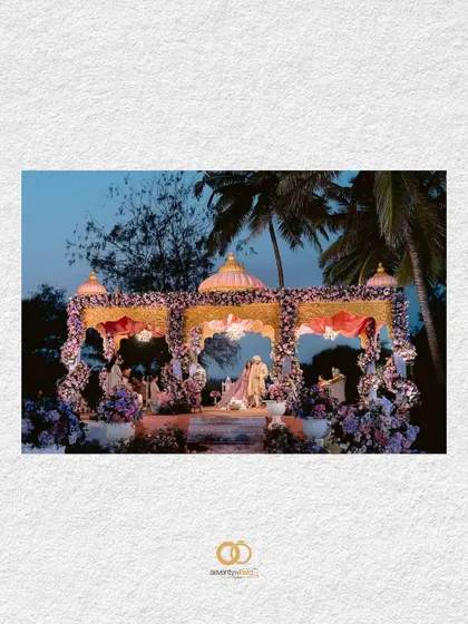 A beautifully framed shot of the wedding mandap in Goa, set against the evening sky, hinting at the grandeur and romance of the ceremony to come.