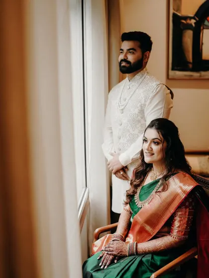A poised and elegant portrait of the couple. This shot showcases their beautiful traditional outfits and the grace of the occasion.