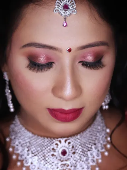A close up of the sparkling pink and silver eye makeup, perfect for a glamorous reception or sangeet.