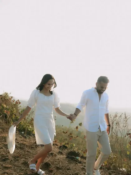 A carefree walk through a hilly landscape, capturing the couple's adventurous spirit in their pre-wedding photos.
