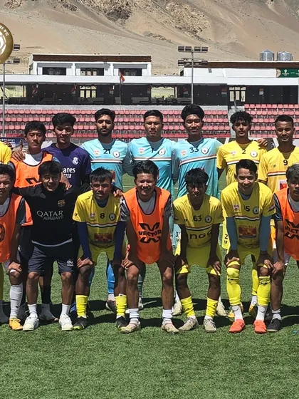 The full squad, including players in training bibs, getting ready for a friendly match in the mountains of Ladakh.