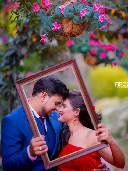 A creative and romantic shot with the couple framed by a picture frame. This is a fun and unique way to create a memorable pre-wedding photo.