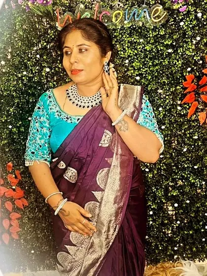 The rich colors of this saree and blouse combination make it a perfect choice for an evening event.