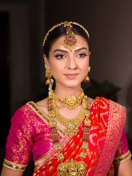 A close-up of this stunning South Indian inspired look. The makeup is classic and golden, perfect for a traditional event.