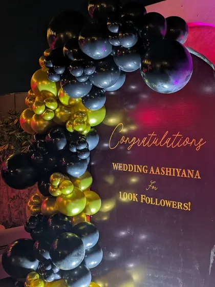 A close-up detail of the top of the balloon arch on the corporate backdrop. The careful placement of balloons ensures a full and professional appearance from every angle.