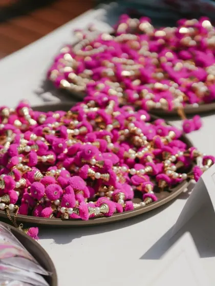 Bright pink ghungroo bracelets ready for guests to wear and enjoy at the Mehendi party.