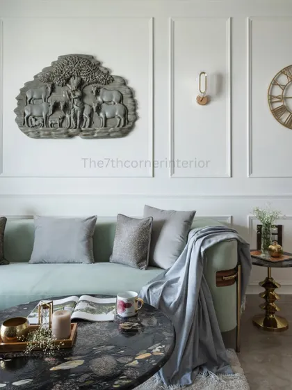 Detail of the living area, highlighting the black marble-topped center table and the custom Krishna artwork, which was tailored to the client’s preferences and illuminated by a dedicated spotlight.