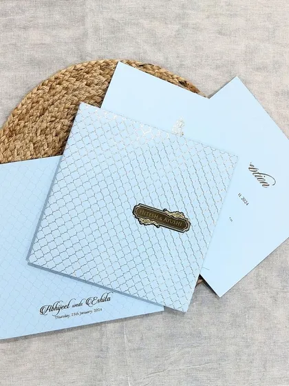 A premium pastel blue invitation with a subtle pattern and a personalized nameplate, offering a chic and modern option.