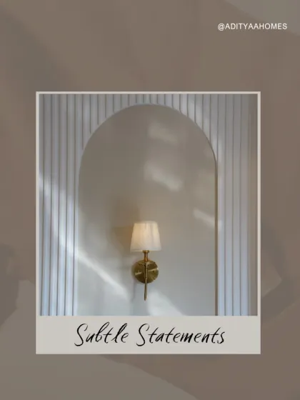 Subtle statements can make the biggest impact. A simple, elegant wall sconce set in an arched niche with a textured backdrop creates a feeling of peace and luxury.