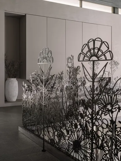 A perspective shot of the floral metal railing, emphasizing its three-dimensional quality and the way it guides the eye through the space.