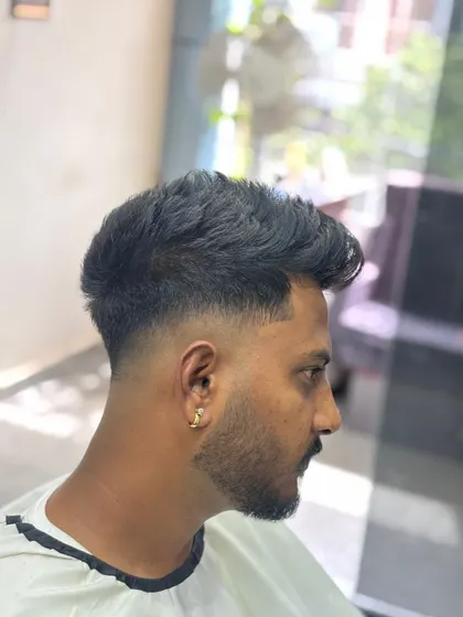 A clean taper fade with a textured top. This is a great option for a professional yet modern look.