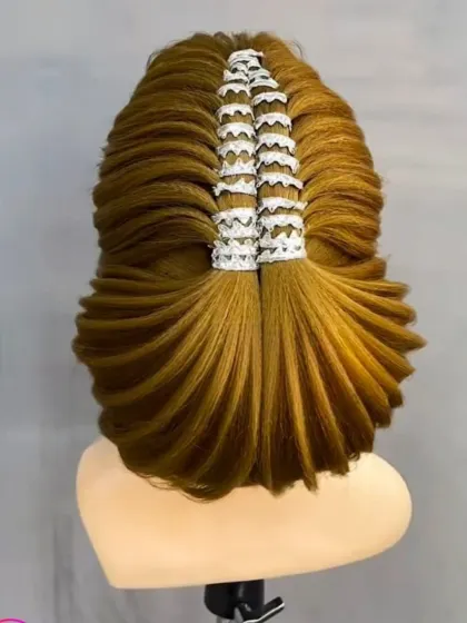 A highly structured and modern updo, showing the creative and architectural side of hairstyling.