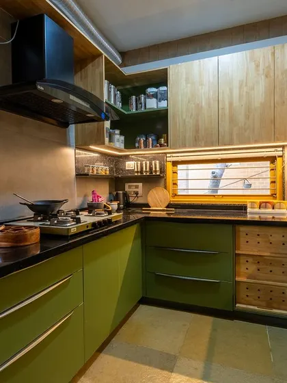 The kitchen is designed with ample storage, including custom drawers and open shelving.