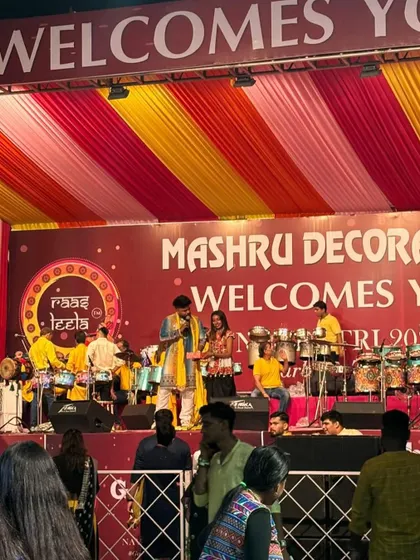 On stage at the Raasleela Navratri event, with the drummers and musicians in the background.