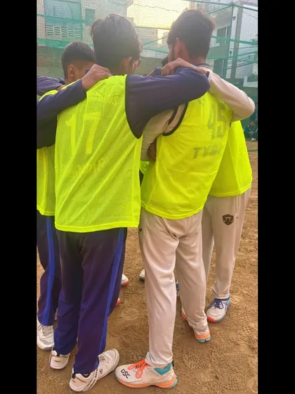A coach joins the huddle, giving last-minute instructions and encouragement.