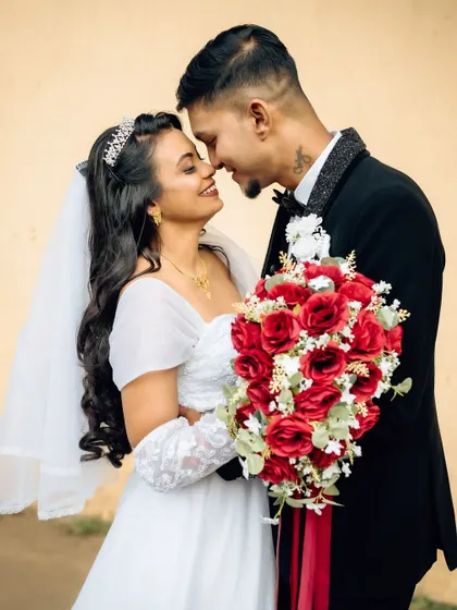 A classic and romantic pose, with the couple sharing a quiet moment nose-to-nose. This highlights their connection and the details of their wedding attire.