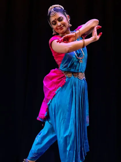 A graceful pose from a performance, expressing gratitude for the artistic opportunities of the year.