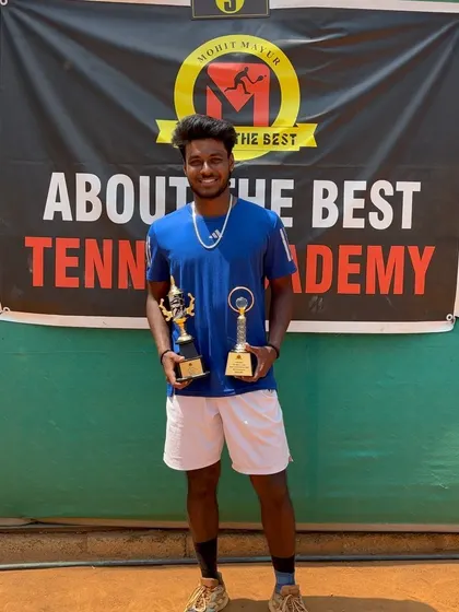 A player showcasing his trophies after a successful week at our hosted AITA 1 Lakh tournament. We provide a platform for players to compete for significant prize money and ranking points.