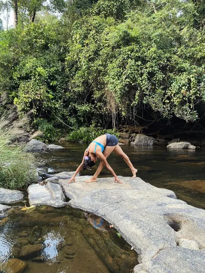 Awaken your inner vision. A revolved side angle pose on the rocks in Coorg, embracing all aspects of myself without judgment.