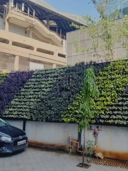 We transform large urban spaces with expansive green facades. This project turned a plain retaining wall in a parking area into a dynamic, patterned vertical garden, bringing a touch of nature to the concrete landscape.