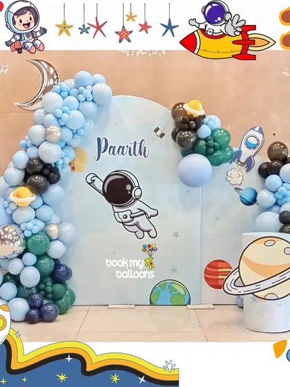 Paarth's birthday was an adventure into outer space. This clean and modern astronaut theme featured a custom backdrop with a floating astronaut, planet cutouts, and a beautiful balloon arch in shades of blue and black.