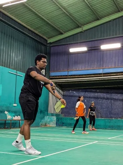 An adult player practices his serve during a group coaching session. We offer dedicated batches for adults who are new to the game or looking to refine their skills.