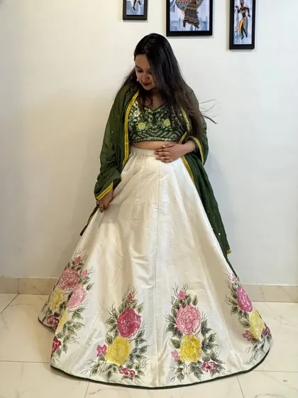 This shot highlights the gorgeous floral painting on the border of the skirt, showing the detail and craftsmanship involved.