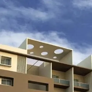 A view of a modern roof structure featuring multiple circular skylights. This design choice is both functional, allowing light into the space below, and aesthetically interesting.