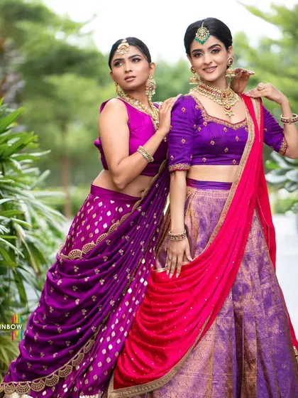 A full-length shot of two models in our contrasting half sarees, showcasing a complete look from head to toe.