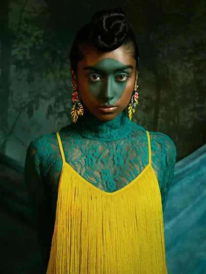 A striking close-up with bold, graphic makeup inspired by the Brazilian flag. This is a perfect example of a high-concept beauty shot.