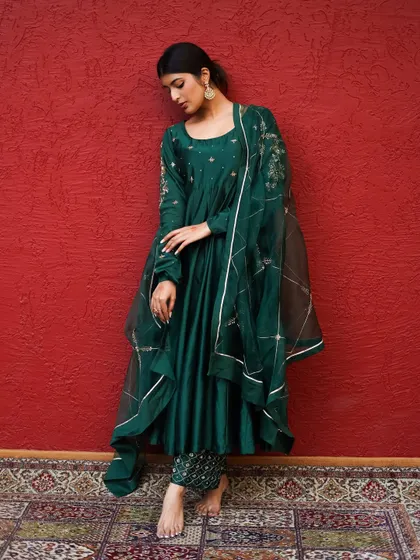 This pose emphasizes the flow and silhouette of the anarkali. It's a classic shot for any ethnic wear lookbook, showing how the garment moves and drapes.