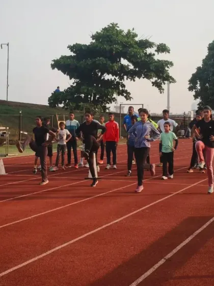 A group of dedicated athletes performs warm-up drills on the track. Proper preparation is crucial for preventing injuries and achieving peak performance during our demanding sessions.