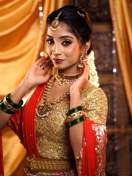 A confident pose from the bride, showing off her complete look. The makeup is designed to empower and make her feel her absolute best.