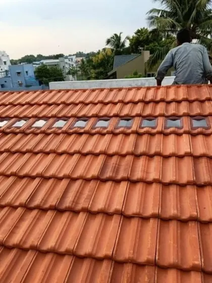 Our skilled team is shown here carefully installing roof tiles on a pergola structure. We ensure every element is perfectly placed for a durable and watertight finish that stands the test of time.