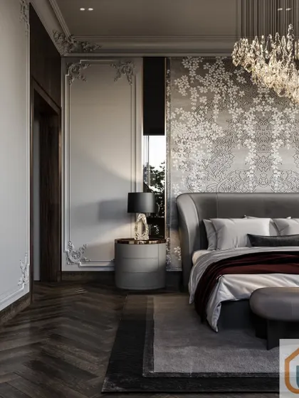 This elegant bedroom features a custom damask wallpaper accent wall behind a sophisticated grey upholstered bed, complemented by a brilliant crystal chandelier.