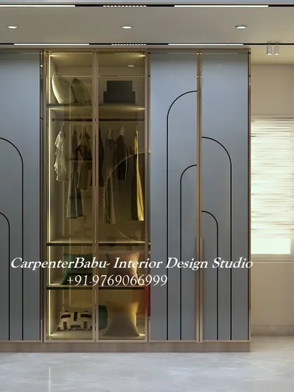 A stunning walk-in closet with glass-fronted wardrobes, internal lighting, and ample storage. This is the epitome of luxury and organization.