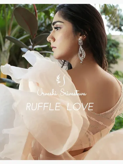 A detailed shot focusing on the makeup and hairstyle for the ruffle saree look. The soft waves and glowing skin complement the delicate fabric, highlighting the romantic feel of the collection.