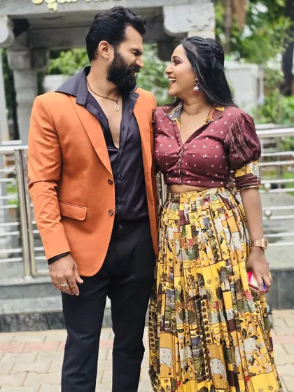 A beautiful shot of the couple, showing how their outfits complement each other. The colours are warm and earthy, perfect for a daytime look.