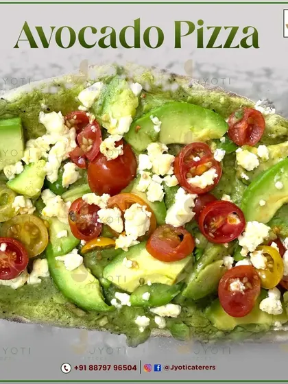 A fresh and healthy Avocado Pizza. This gourmet pizza is topped with a green pesto-like base, fresh avocado slices, cherry tomatoes, and crumbled cheese.