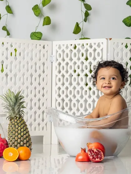 Time for a fruity splash. Our milk bath sessions are a fun, sensory experience for toddlers, resulting in photos filled with giggles and playful energy.