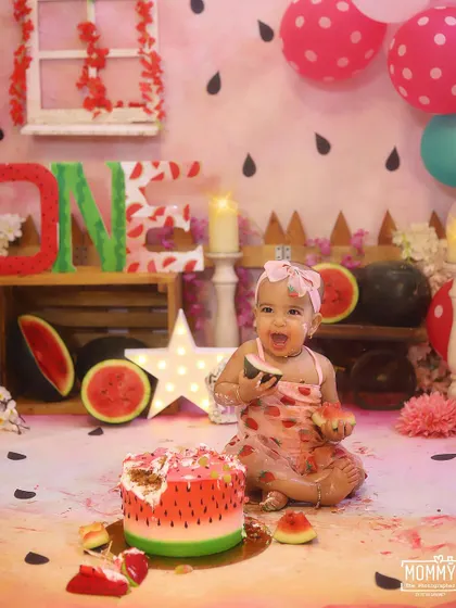 A slice of cake and a slice of watermelon, what could be better? Capturing the pure delight of a baby's first taste of birthday cake.