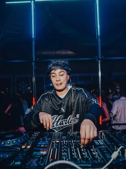 In my element, mixing tracks under the club lights. This is a typical view from my office, focused on the decks and the sound.