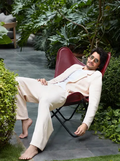 A relaxed moment during the Hello! Magazine shoot with Mahesh Babu. The outdoor garden setting and casual linen suit create a soft, approachable feel, showing a different side to his personality.