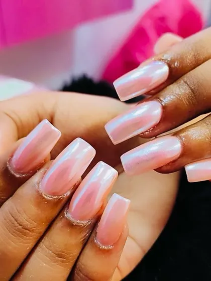 These square-tipped nails showcase a beautiful pearlescent pink chrome finish. The polish has a soft, milky iridescence that catches the light, creating a dreamy and elegant look.