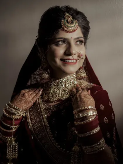 A bright, joyful portrait capturing the bride looking away with a happy, natural smile.