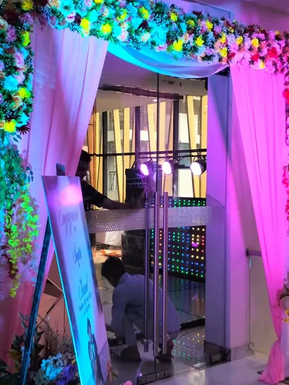 Another angle of the engagement party entrance, showing the floral decor and the custom welcome sign.
