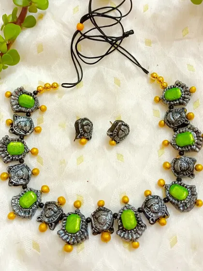 The Durga motif choker with light green stones, another beautiful color option for your festive collection.
