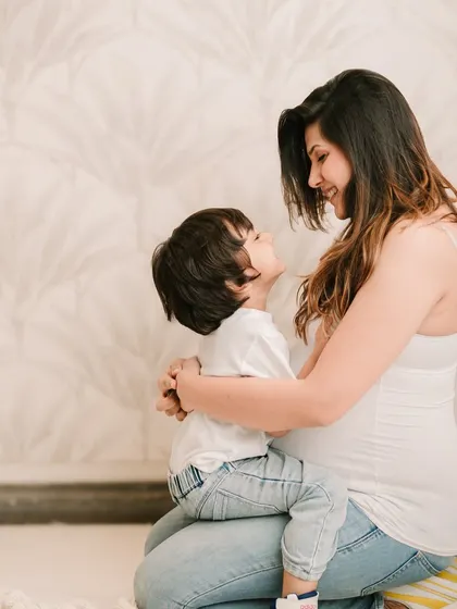 A beautiful interaction between a mother-to-be and her son, full of love and anticipation.