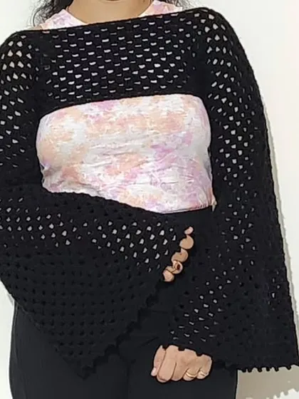A full view of the Retro Shrug, showcasing its cropped fit and dramatic silhouette.